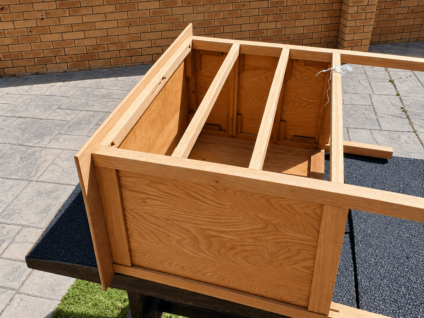The oak chest refinished by hand to a warm natural tone, restored as a freestanding piece